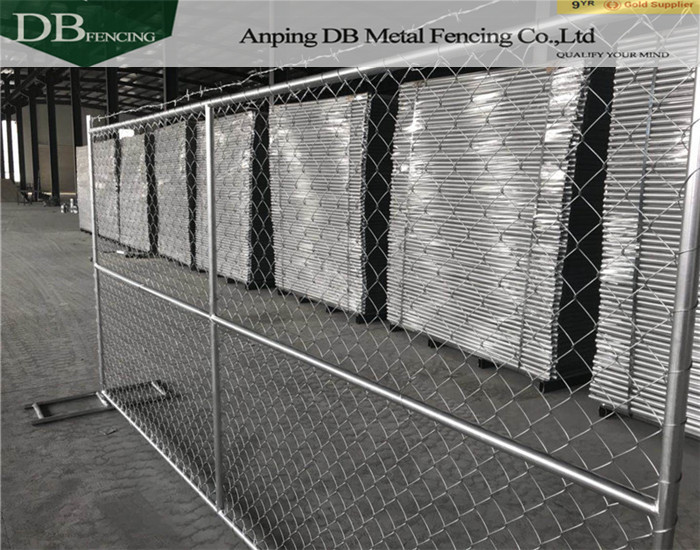 temporary chain link fence installed with barbed wire