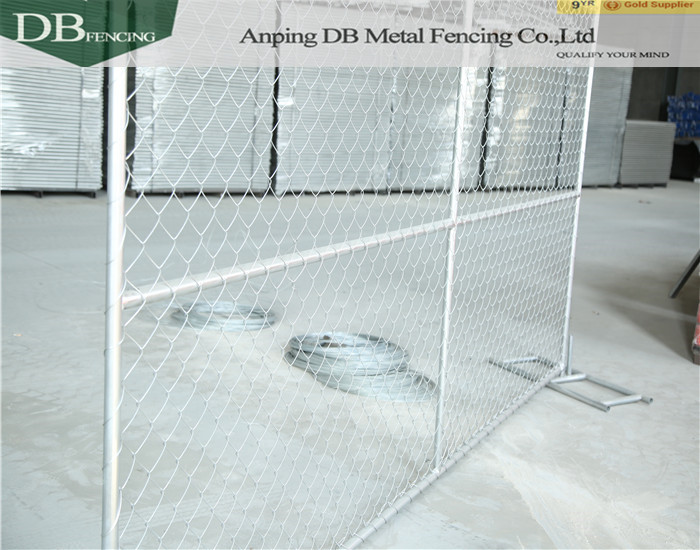 temporary chain link fence installed with barbed wire